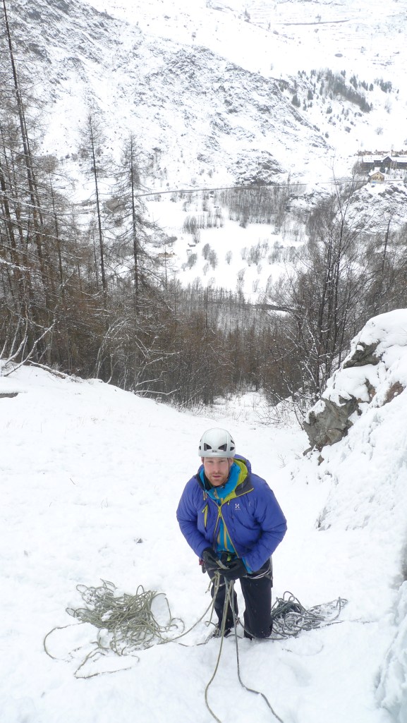 The Haglöfs Barrier Pro II Belay Jacket has a 2 way zip, a crucial feature on proper belay jackets. Try to size it to fit over your out layers. 