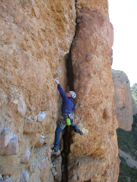 The Arcteryx Cerium SL Jacket is great as a lightweight belay jacket. Seen here in it's integrated stuff sack, clipped to the back of my harness whilst climbing multi pitch routes in Riglos, Spain.